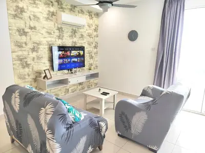 a living room with two chairs and a tv at Exclusive Studio/ 1~4pax/ Gurney/ Mansion One in George Town