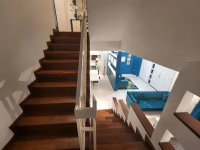 a staircase in a house with a glass railing at Solok Burma Vacation Home @ Gurney Penang in George Town
