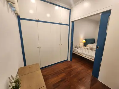 a bedroom with a bed and a large closet at Solok Burma Vacation Home @ Gurney Penang in George Town