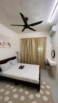 a bedroom with a bed with a ceiling fan at D Naurah Meritus Guesthouse in Perai