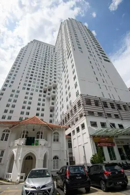 a large white building with cars parked in front of it at 2R1B/Seaview Tropical /1~8Pax/Gurney Mansion One in George Town