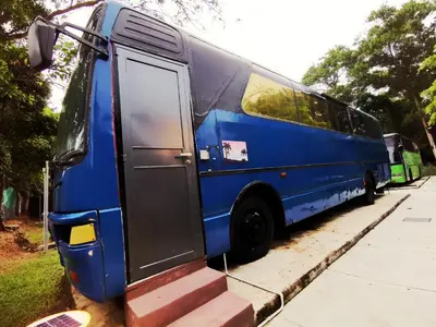 a blue bus parked on the side of a street at Pangkor Bus Resort by BESLA in Pangkor