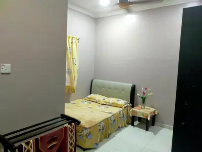a small bedroom with a bed and a chair at Villa Auliyya - MusleemHomestay in Kampong Sungai Leman