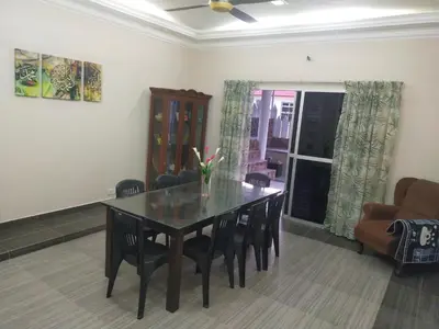 a dining room with a table and chairs at Villa Auliyya - MusleemHomestay in Kampong Sungai Leman