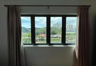 a window with a view of a city at NEW 6pax 3BR Sunrise view 100m Attractive Places Kea Farm in Cameron Highlands
