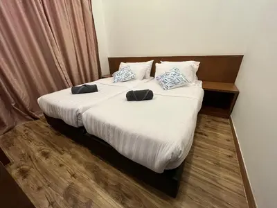 a bedroom with a bed with two pillows on it at NEW 6pax 3BR Sunrise view 100m Attractive Places Kea Farm in Cameron Highlands