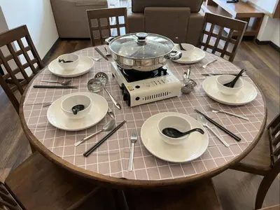 a table with plates and a pot on top of it at NEW 6pax 3BR Sunrise view 100m Attractive Places Kea Farm in Cameron Highlands