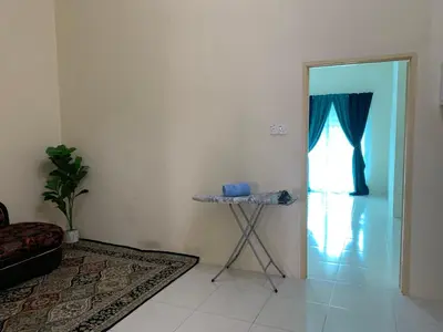 a room with a table and a door with a window at ZillQayyim Homestay in Seri Iskandar