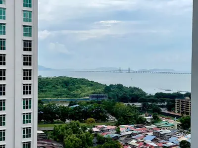 a view of a city from between two buildings at Pool View Stylish Suite at Jelutong Penang 1-4pax in George Town