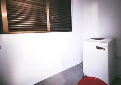 a bathroom with a small refrigerator and a window at Ipoh Town Kinta Riverfront Apartment 7pax by Glamorous in Ipoh