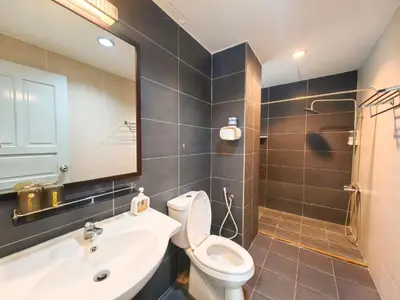 a bathroom with a toilet and a sink and a mirror at Ipoh Town Kinta Riverfront Apartment 7pax by Glamorous in Ipoh