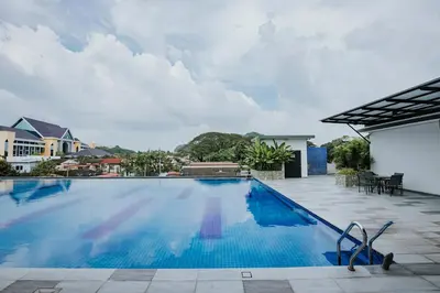 a large swimming pool with blue water at Ipoh Town Kinta Riverfront Apartment 7pax by Glamorous in Ipoh