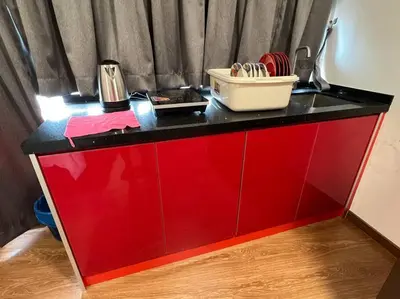 a red counter with a black top at NEW 6Pax SOHO Near USM & SPICE ARENA & AIRPORT in Bayan Lepas