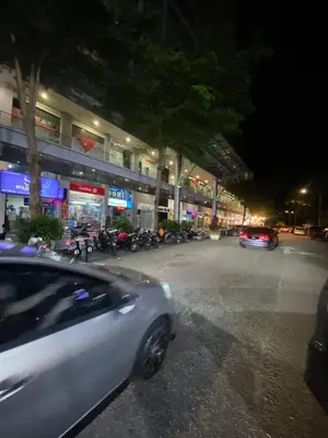 a white car driving down a city street at night at NEW 6Pax SOHO Near USM & SPICE ARENA & AIRPORT in Bayan Lepas