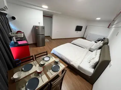 a small room with a bed and a table at NEW 6Pax SOHO Near USM & SPICE ARENA & AIRPORT in Bayan Lepas