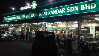 a sign for a restaurant on a street at night at NEW 6Pax SOHO Near USM & SPICE ARENA & AIRPORT in Bayan Lepas