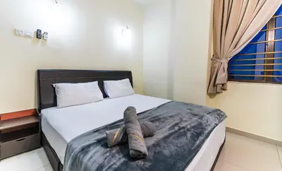 a bedroom with a bed with a towel on it at Batu Ferringhi Sea View Penthouse Resort Home in Bayan Lepas