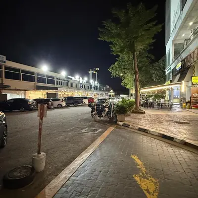 a street at night with cars parked in a parking lot at 6PAX 1 BEDROOM SOHO Near USM SPICE ARENA PANTAI SPECIALIST AIRPORT in Bayan Lepas