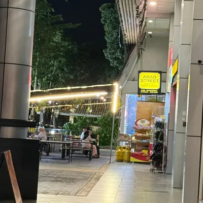 a restaurant with people sitting at tables at night at 6PAX 1 BEDROOM SOHO Near USM SPICE ARENA PANTAI SPECIALIST AIRPORT in Bayan Lepas
