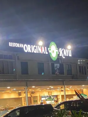 a restaurant original kiwi sign on top of a building at 6PAX 1 BEDROOM SOHO Near USM SPICE ARENA PANTAI SPECIALIST AIRPORT in Bayan Lepas