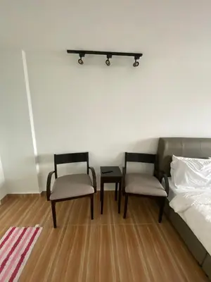 a bedroom with two chairs and a bed and a table at 6PAX 1 BEDROOM SOHO Near USM SPICE ARENA PANTAI SPECIALIST AIRPORT in Bayan Lepas