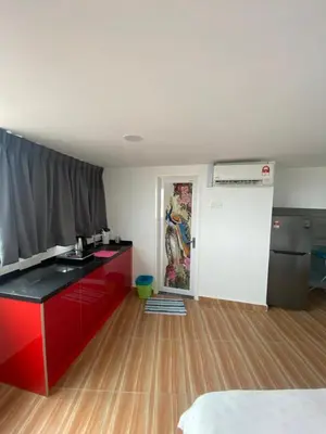 a room with a red counter top and a kitchen at 6PAX 1 BEDROOM SOHO Near USM SPICE ARENA PANTAI SPECIALIST AIRPORT in Bayan Lepas