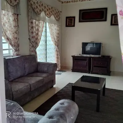 a living room with a couch and a tv at Zulkifli Homestay Tambun,Ulu kinta,Tg Rambutan in Ipoh