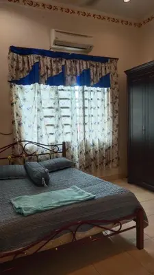a bedroom with a bed and a window with curtains at Zulkifli Homestay Tambun,Ulu kinta,Tg Rambutan in Ipoh