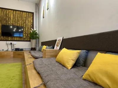 a living room with two couches and a flat screen tv at Ipoh Family Masjid Muhammadiah Evicharger SY15 in Ipoh