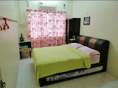 a bedroom with a bed and a pink curtain at HEAWOOD GUEST HOUSE Sungai Siput in Sungai Siput