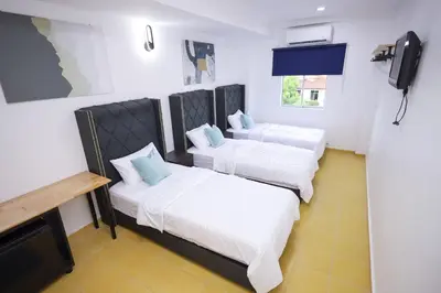 a room with two beds and a flat screen tv at RENTIO HOTEL in Kulim