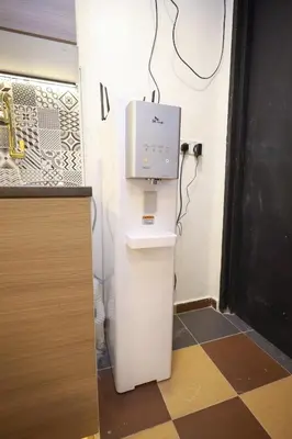 a room with a toilet with a box on the wall at RENTIO HOTEL in Kulim
