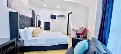 a hotel room with a bed and a couch at RENTIO HOTEL in Kulim