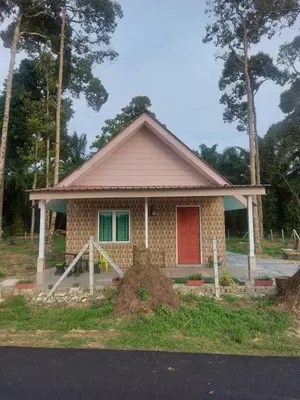 a small house with a red door at Rumah Kebun by Panorama Homestay in Lambor Kanan