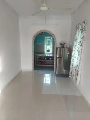 a kitchen with a refrigerator in a white room at Rumah Kebun by Panorama Homestay in Lambor Kanan