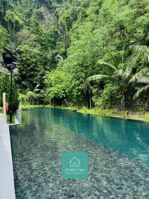 a swimming pool in the middle of a river at Jomstay The Cove Ipoh Hillside Residence in Ipoh