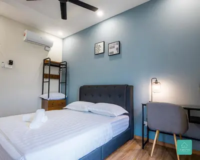 a small bedroom with a bed and a chair at Jomstay The Cove Ipoh Hillside Residence in Ipoh