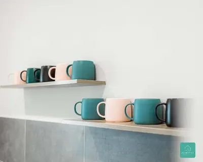 a row of coffee cups on shelves in a kitchen at Jomstay The Cove Ipoh Hillside Residence in Ipoh
