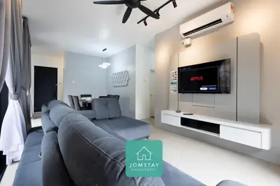 a living room with a couch and a flat screen tv at Jomstay The Cove Ipoh Hillside Residence in Ipoh