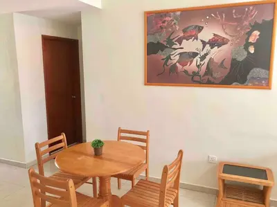 a dining room with a wooden table and chairs at Natural Paradise 3Mins to Beach at Teluk Batik Lumut in Lumut
