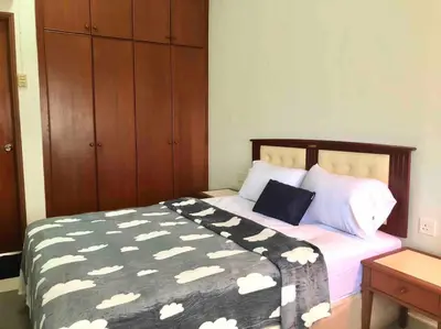 a bedroom with a bed with a black and white comforter at Natural Paradise 3Mins to Beach at Teluk Batik Lumut in Lumut