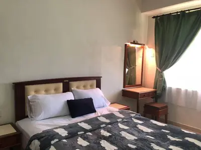 a bedroom with a large bed and a mirror at Natural Paradise 3Mins to Beach at Teluk Batik Lumut in Lumut