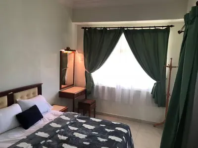 a bedroom with a bed and a large window at Natural Paradise 3Mins to Beach at Teluk Batik Lumut in Lumut