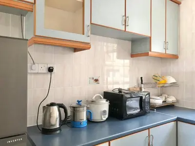 a kitchen counter with a microwave and a toaster oven at Natural Paradise 3Mins to Beach at Teluk Batik Lumut in Lumut