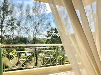 a window with a view of a balcony with trees at Natural Paradise 3Mins to Beach at Teluk Batik Lumut in Lumut
