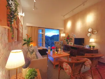 a living room with a couch and a table at Green Hill Apartment in Tanah Rata