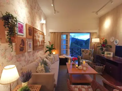 a living room with a couch and a table at Green Hill Apartment in Tanah Rata