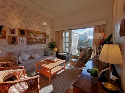 a living room with a couch and a table at Green Hill Apartment in Tanah Rata