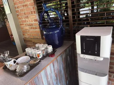 a coffee machine sitting on a counter next to cups at Pangkor Nature View House in Pangkor