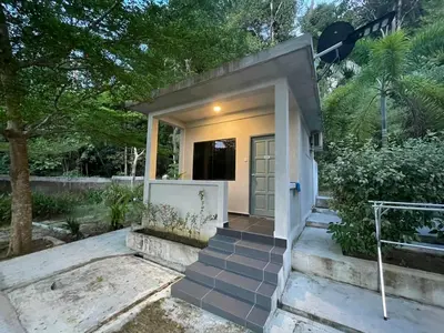 a small house with a staircase leading to a door at Pangkor Nature View House in Pangkor